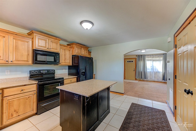 2724 Overlook Blvd, Helena, MT 59601 - kitchen featuring black appliances, arched walkways, light countertops, light tile patterned flooring, and a center island