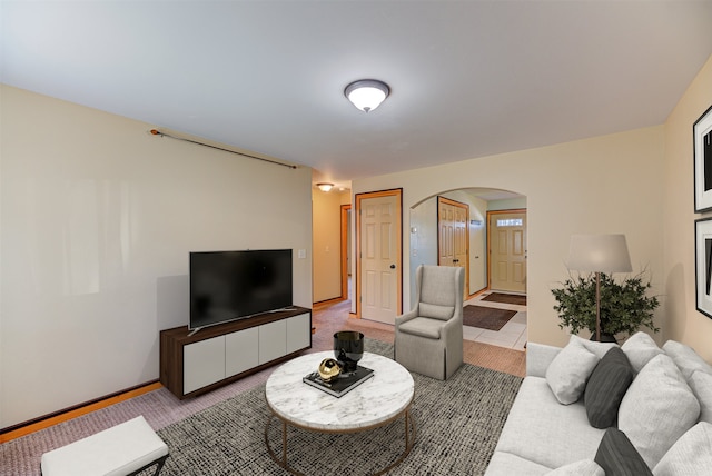 2724 Overlook Blvd, Helena, MT 59601 - living room featuring arched walkways, baseboards, and light carpet