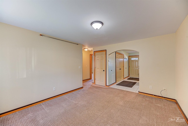 2724 Overlook Blvd, Helena, MT 59601 - spare room with arched walkways, light carpet, and baseboards
