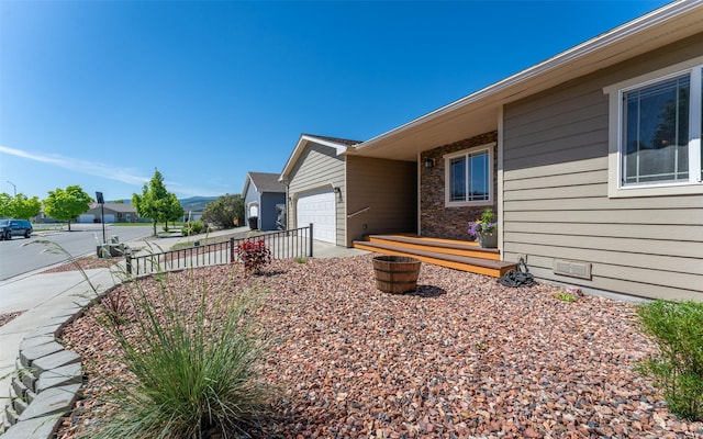 2216 Ruddy Duck Dr, Kalispell, MT 59901 - view of property exterior featuring an attached garage and driveway