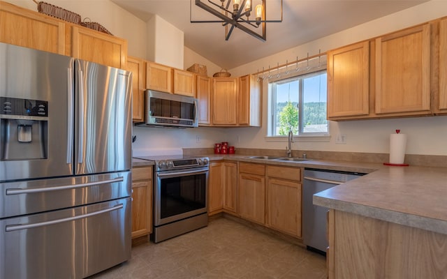 2216 Ruddy Duck Dr, Kalispell, MT 59901 - kitchen with stainless steel appliances, vaulted ceiling, a chandelier, and light brown cabinetry