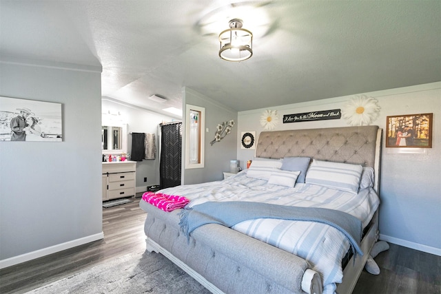 13414 Ashlyn Dr, Missoula, MT 59808 - bedroom featuring wood finished floors, baseboards, vaulted ceiling, and a textured ceiling