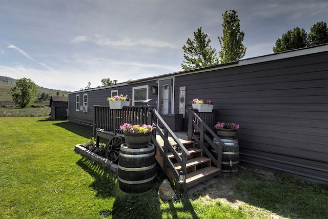 13414 Ashlyn Dr, Missoula, MT 59808 - rear view of house featuring a yard and a wooden deck