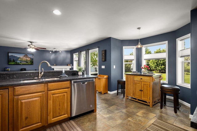 25 Logan Way, Kalispell, MT 59901 - kitchen with dishwasher, brown cabinetry, dark stone finish flooring, a ceiling fan, and hanging light fixtures