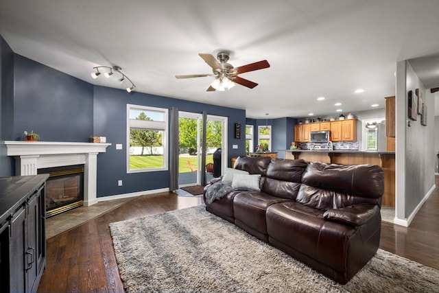 25 Logan Way, Kalispell, MT 59901 - living area with a ceiling fan, dark wood-style flooring, recessed lighting, and a fireplace with flush hearth
