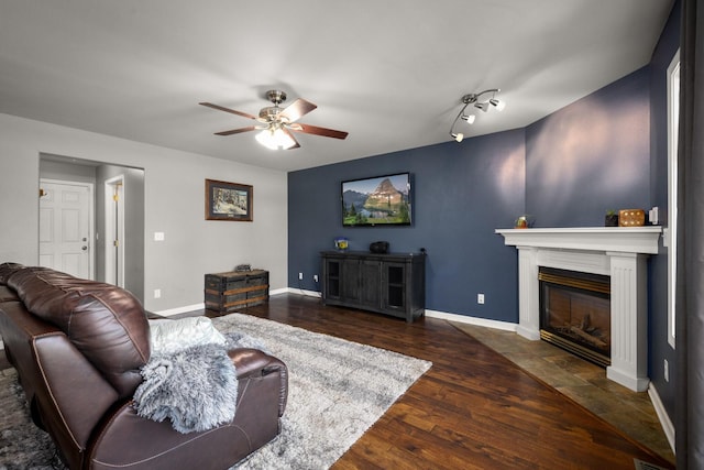 25 Logan Way, Kalispell, MT 59901 - living area with a ceiling fan, a fireplace with flush hearth, and wood finished floors