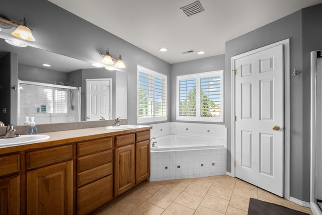 25 Logan Way, Kalispell, MT 59901 - full bathroom with a shower stall, tile patterned flooring, a bath, double vanity, and recessed lighting