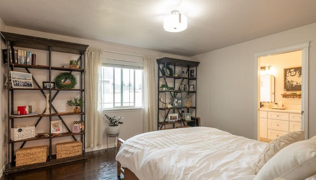 140 Ali Loop, Kalispell, MT 59901 - bedroom featuring dark wood-style flooring and connected bathroom