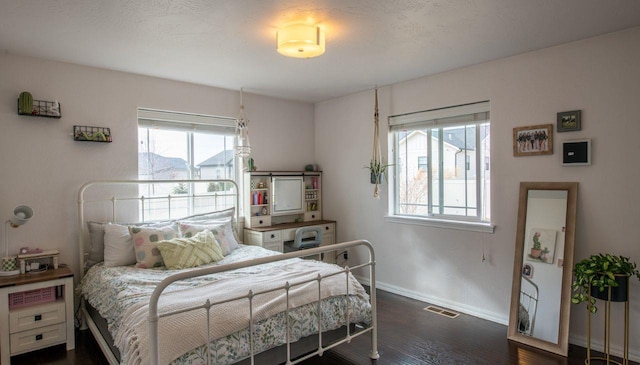 140 Ali Loop, Kalispell, MT 59901 - bedroom featuring multiple windows and dark wood-type flooring