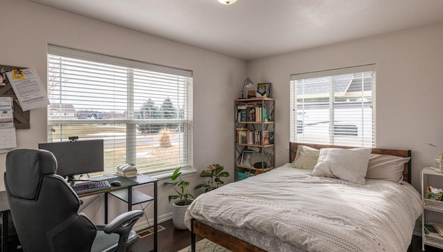 140 Ali Loop, Kalispell, MT 59901 - bedroom with multiple windows, wood finished floors, and an office area