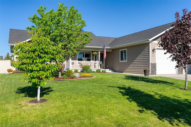 140 Ali Loop, Kalispell, MT 59901 - view of front of property with a garage, a porch, a front lawn, driveway, and stone siding