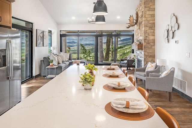 77 Rumsey Rd, Philipsburg, MT 59858 - dining area featuring dark wood finished floors, lofted ceiling, and baseboards