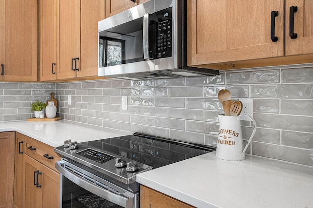 77 Rumsey Rd, Philipsburg, MT 59858 - kitchen with stainless steel appliances, decorative backsplash, and light countertops