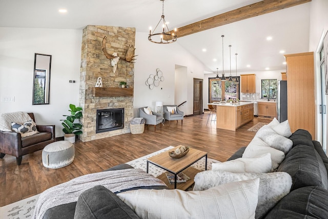 77 Rumsey Rd, Philipsburg, MT 59858 - living room with a chandelier, beam ceiling, dark wood finished floors, recessed lighting, and a stone fireplace