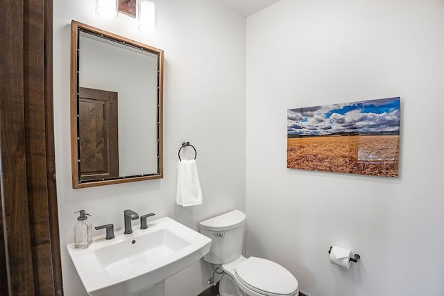 77 Rumsey Rd, Philipsburg, MT 59858 - bathroom featuring toilet, a sink, and baseboards
