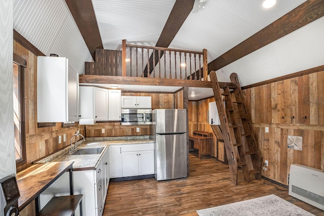 77 Rumsey Rd, Philipsburg, MT 59858 - kitchen with stainless steel appliances, wooden walls, a sink, heating unit, and light countertops
