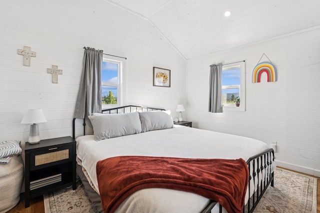 515 Manning Rd, Kalispell, MT 59901 - bedroom with wood finished floors, lofted ceiling, baseboards, and wooden walls