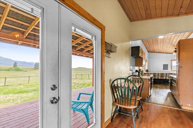 2571 Airport Rd, Eureka, MT 59917 - doorway featuring dark wood finished floors, wooden ceiling, a mountain view, and a view of rural / pastoral area