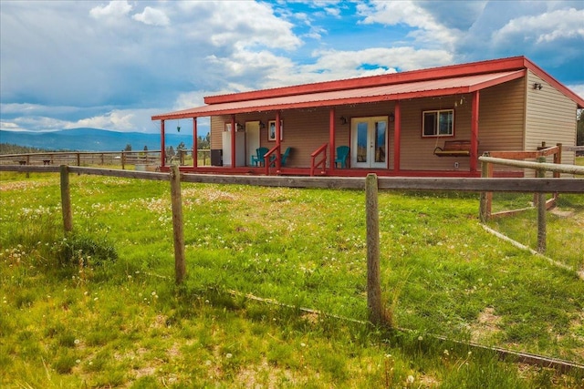 2571 Airport Rd, Eureka, MT 59917 - back of property featuring a porch, french doors, and a mountain view