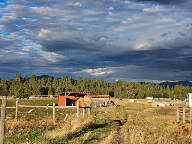 2571 Airport Rd, Eureka, MT 59917 - view of yard with a rural view, a mountain view, an outbuilding, a view of trees, and a pole building