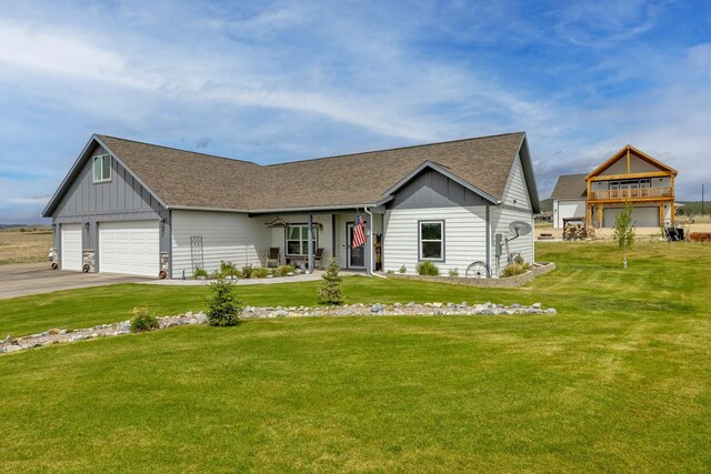 2320 Kenai Rd, Helena, MT 59602 - view of front of house with board and batten siding, a front yard, and roof with shingles