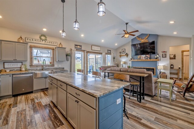 2320 Kenai Rd, Helena, MT 59602 - kitchen with stainless steel dishwasher, a sink, a ceiling fan, light wood finished floors, and gray cabinets