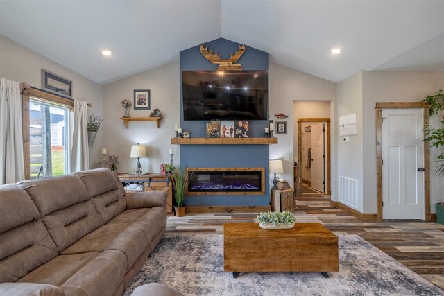 2320 Kenai Rd, Helena, MT 59602 - living room with wood finished floors, vaulted ceiling, a glass covered fireplace, baseboards, and recessed lighting