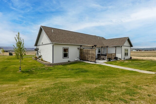 2320 Kenai Rd, Helena, MT 59602 - back of house with a yard and roof with shingles