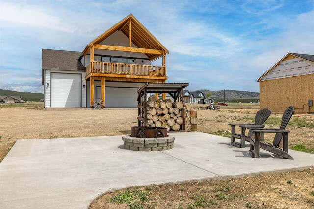 2320 Kenai Rd, Helena, MT 59602 - rear view of property with a fire pit, a patio, and a mountain view