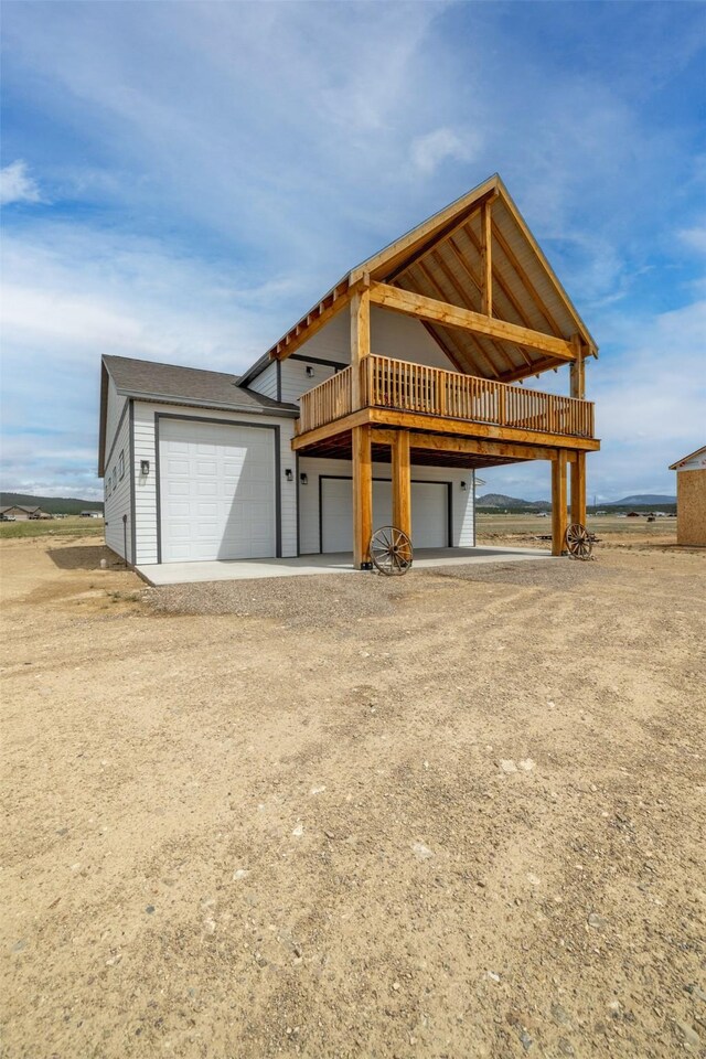 2320 Kenai Rd, Helena, MT 59602 - view of front facade with a deck and dirt driveway