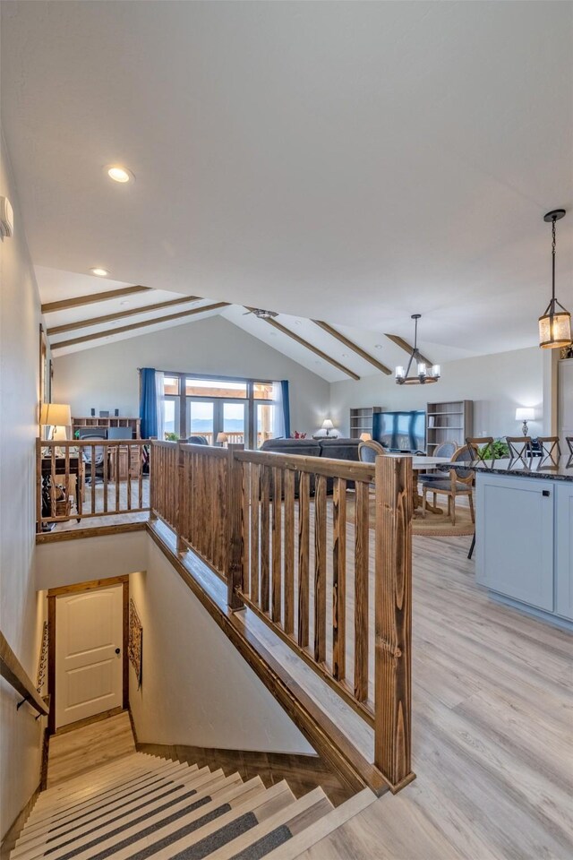 2320 Kenai Rd, Helena, MT 59602 - staircase featuring lofted ceiling, wood finished floors, a chandelier, and recessed lighting