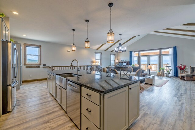 2320 Kenai Rd, Helena, MT 59602 - kitchen featuring appliances with stainless steel finishes, a sink, a center island with sink, open floor plan, and light wood finished floors