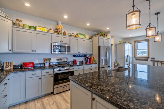 2320 Kenai Rd, Helena, MT 59602 - kitchen with stainless steel appliances, decorative light fixtures, light wood-style floors, recessed lighting, and a sink