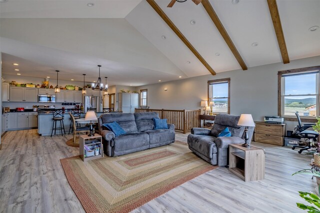 2320 Kenai Rd, Helena, MT 59602 - living room featuring light wood finished floors, high vaulted ceiling, beamed ceiling, ceiling fan, and a chandelier