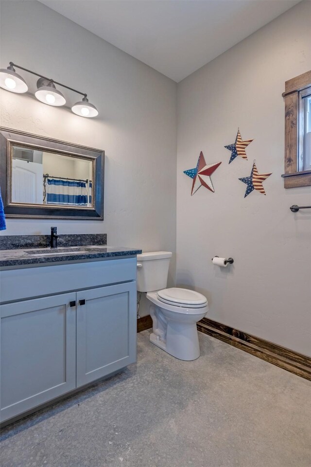 2320 Kenai Rd, Helena, MT 59602 - full bathroom with toilet, baseboards, and vanity