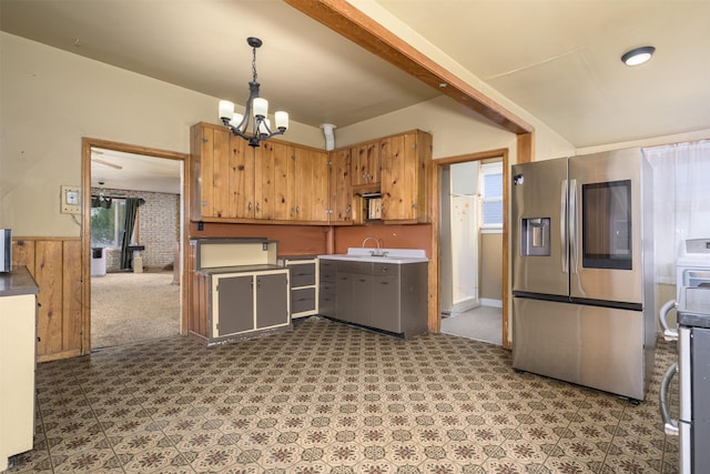 505 Oak St, Anaconda, MT 59711 - kitchen with stainless steel fridge, a chandelier, a sink, decorative light fixtures, and a wainscoted wall