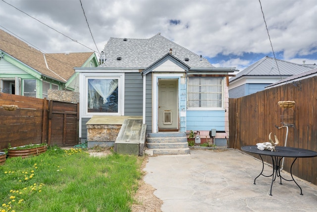 505 Oak St, Anaconda, MT 59711 - view of front of property with a fenced backyard, entry steps, a patio area, and a shingled roof