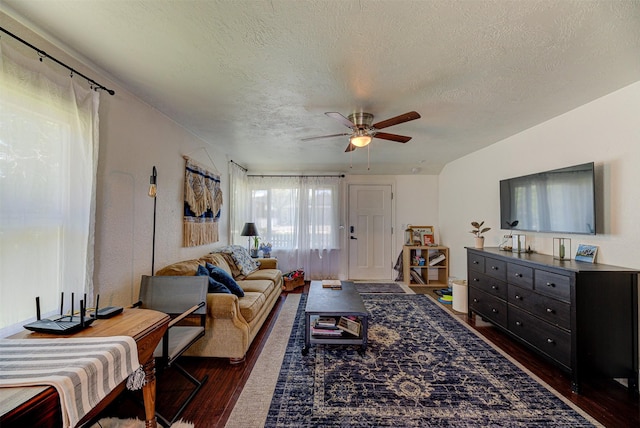 1202 Walnut St, Helena, MT 59601 - living area featuring dark wood-style floors, a ceiling fan, and a textured ceiling