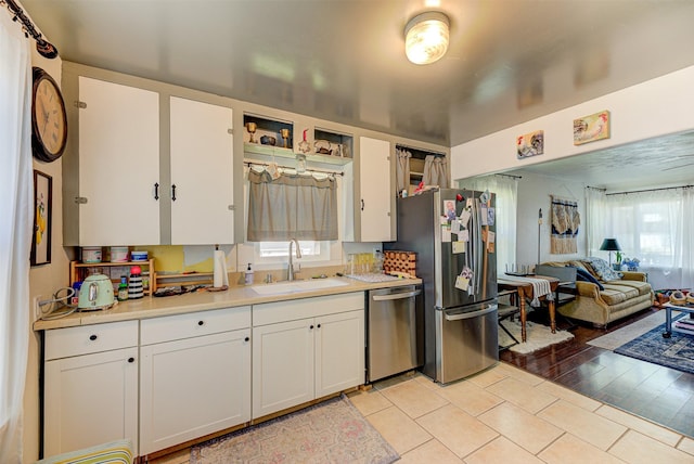 1202 Walnut St, Helena, MT 59601 - kitchen featuring appliances with stainless steel finishes, a sink, and white cabinetry