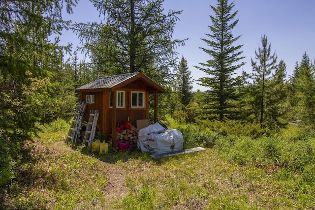 111 Lupfer Loop Rd, Olney, MT 59927 - view of shed featuring a view of trees