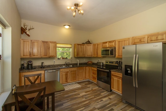 111 Lupfer Loop Rd, Olney, MT 59927 - kitchen featuring stainless steel appliances, dark countertops, a chandelier, and a sink