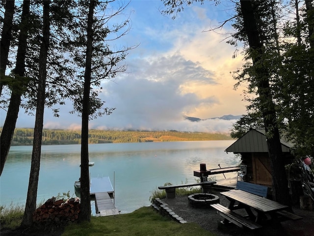 285 Metzner Dr, Trego, MT 59934 - dock featuring a water view and an outdoor fire pit