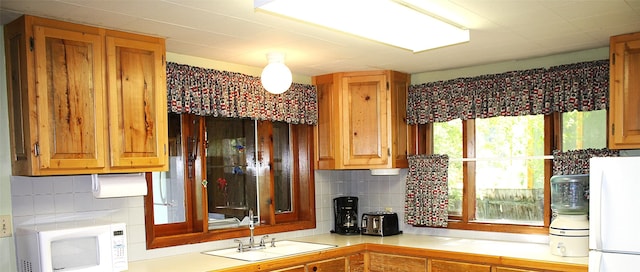 285 Metzner Dr, Trego, MT 59934 - kitchen with white appliances, light countertops, and tasteful backsplash