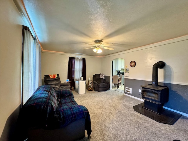 172 Garden Rd, Libby, MT 59923 - living area featuring ornamental molding, carpet floors, a ceiling fan, a textured ceiling, and arched walkways