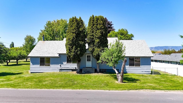 906 11th St E, Polson, MT 59860 - view of front facade with a shingled roof and a mountain view