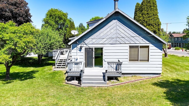 906 11th St E, Polson, MT 59860 - rear view of property featuring a wooden deck, a yard, and stairway
