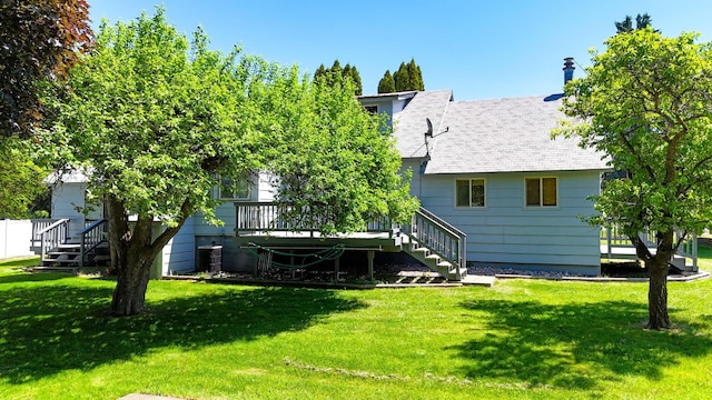 906 11th St E, Polson, MT 59860 - rear view of house featuring stairs, a deck, a yard, and roof with shingles
