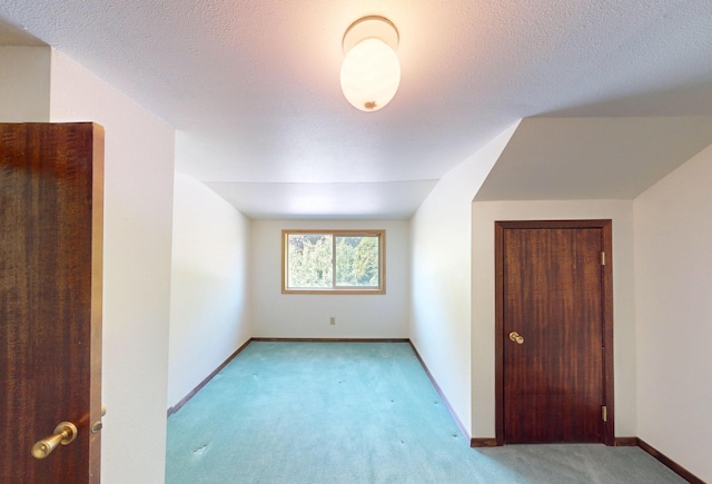 906 11th St E, Polson, MT 59860 - bonus room featuring carpet flooring, baseboards, a textured ceiling, and vaulted ceiling
