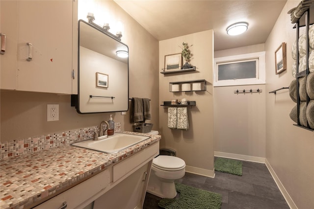 1125 Choteau St, Helena, MT 59601 - half bathroom with toilet, vanity, baseboards, and tile patterned flooring