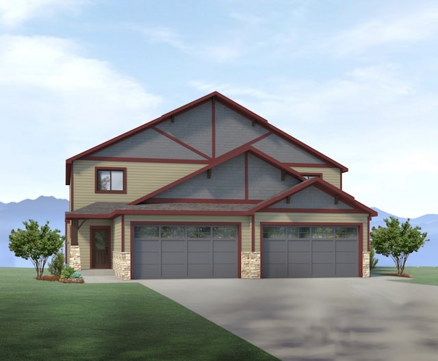 175 Meadow Vista Loop Unit A, Kalispell, MT 59901 - view of front of home with concrete driveway, stone siding, a front yard, and a mountain view